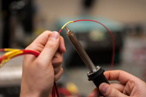 Using a heat gun to fit heatshrink to a wire